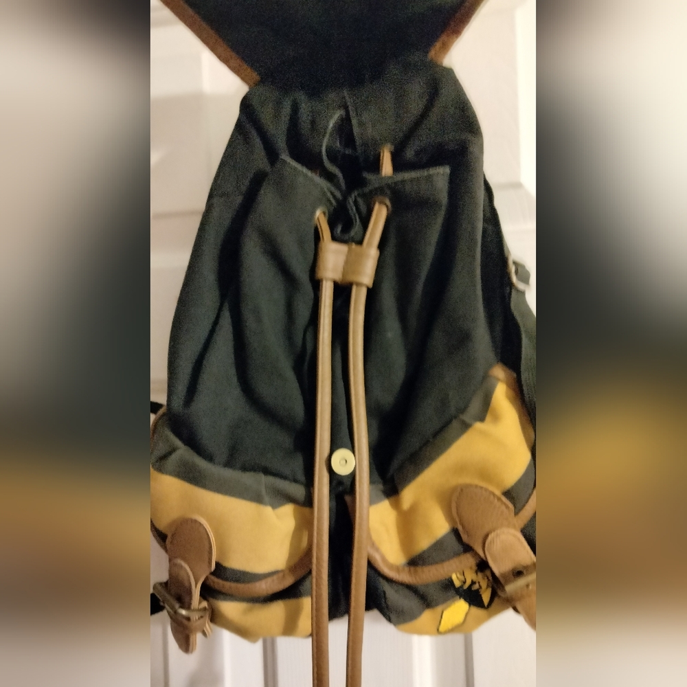 This Harry Potter Hufflepuff Varsity Backpack in black, tan, and gold is a must- - Picture 3 of 7